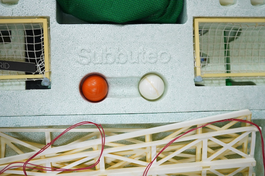 Two boxed Subbuteo table football sets; a European Edition, comprising of two teams, spectators and line side staff, pitch, etc. (some parts missing), and an International Edition, comprising of three teams, stadium ligh